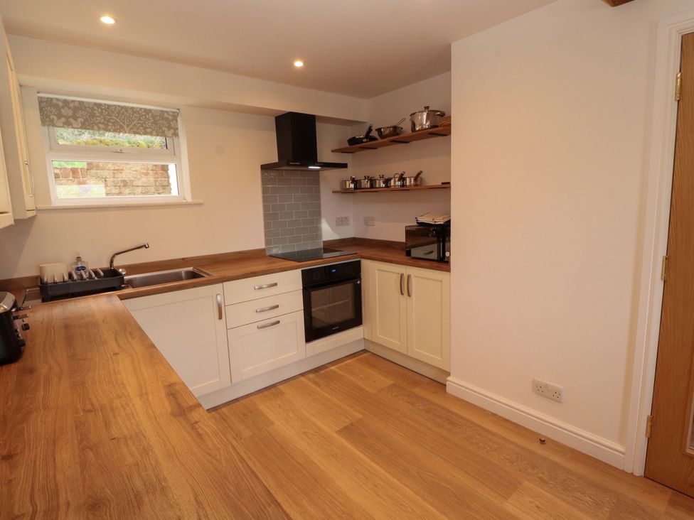 A kitchen with a sink and oven at Bramble Cottage Thornthwaite near Braithwaite