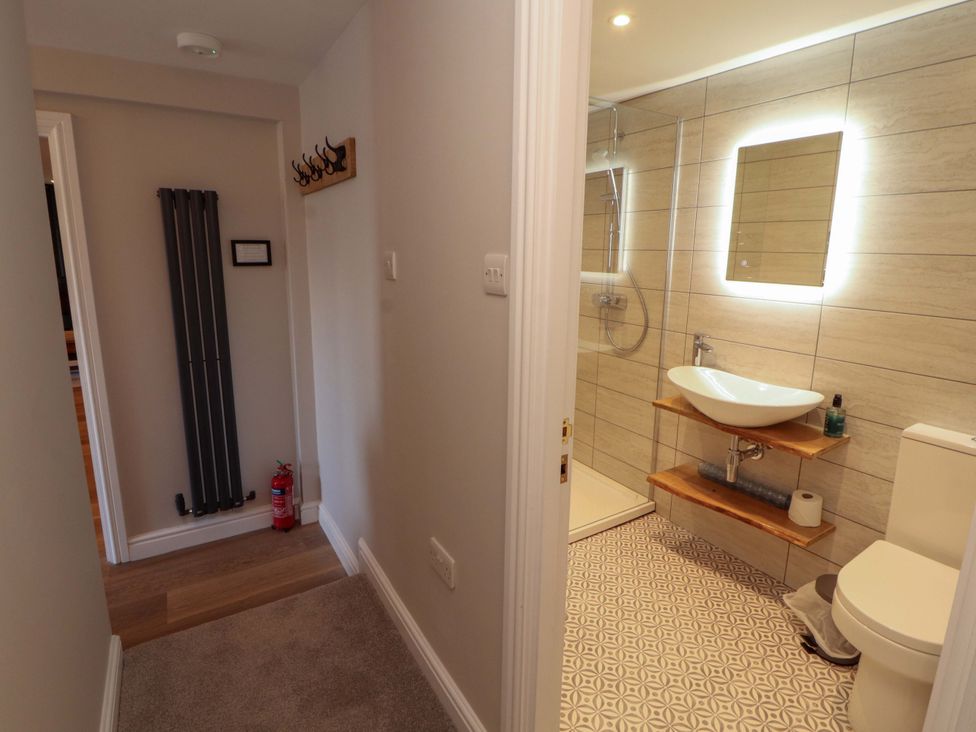 A bathroom with a sink and shower at Bramble Cottage Thornthwaite near Braithwaite