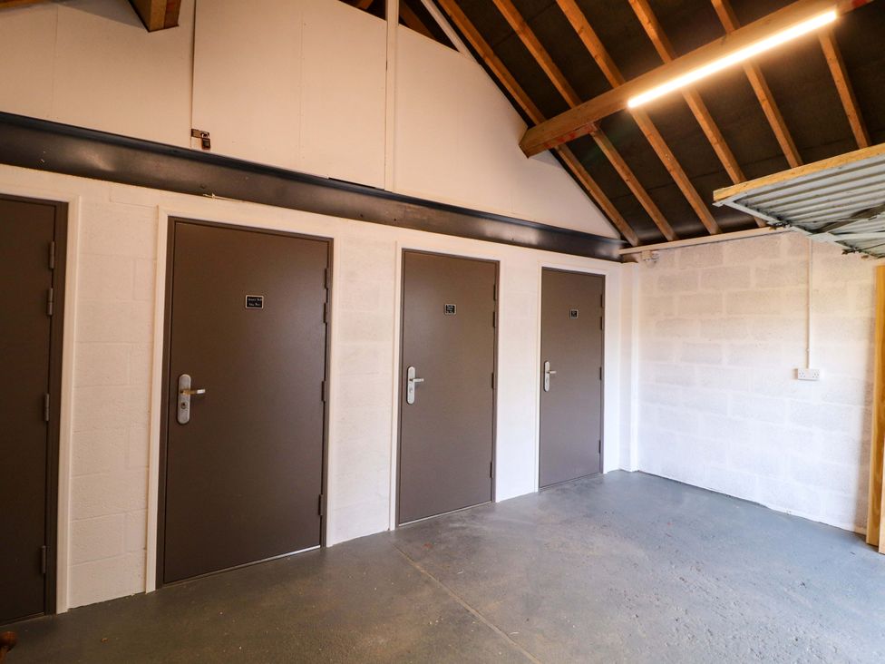 A storage room with multiple doors at Bramble Cottage Thornthwaite near Braithwaite