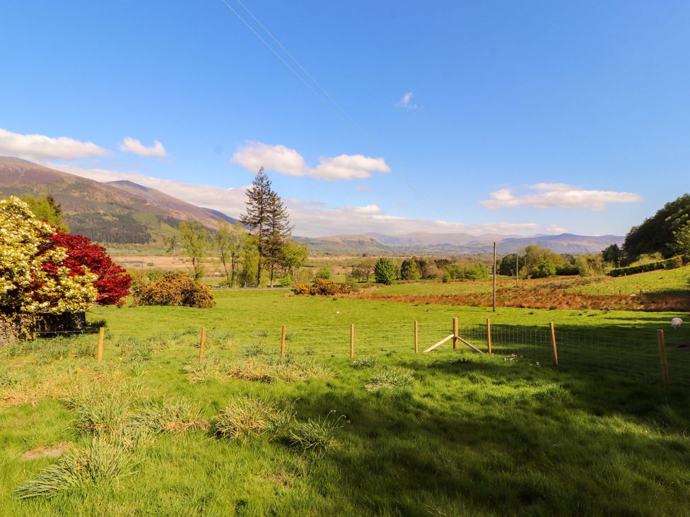 A landscape view with mountains and trees at Bramble Cottage Thornthwaite near Braithwaite