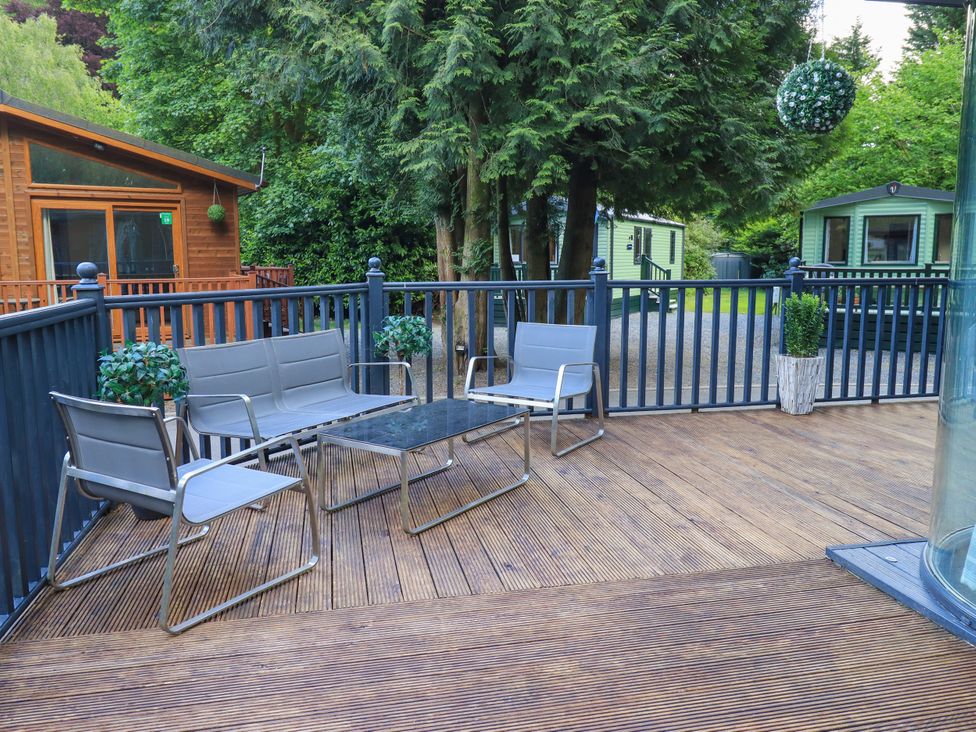An outdoor seating area with chairs and table at Evermore Lodge, 48 Calgarth Park, White Cross Bay, Windermere
