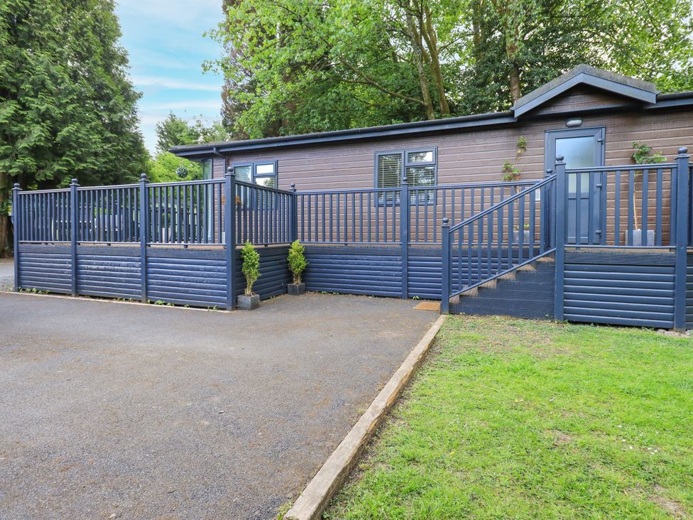 An outdoor view of a building with a railing and steps at Evermore Lodge, 48 Calgarth Park, White Cross Bay, Windermere