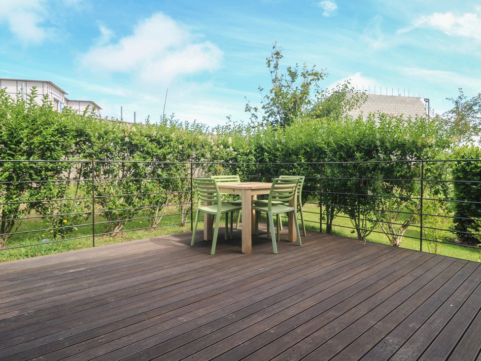 An outdoor area with a table and chairs at Una, Lodge 70, Carbis Bay