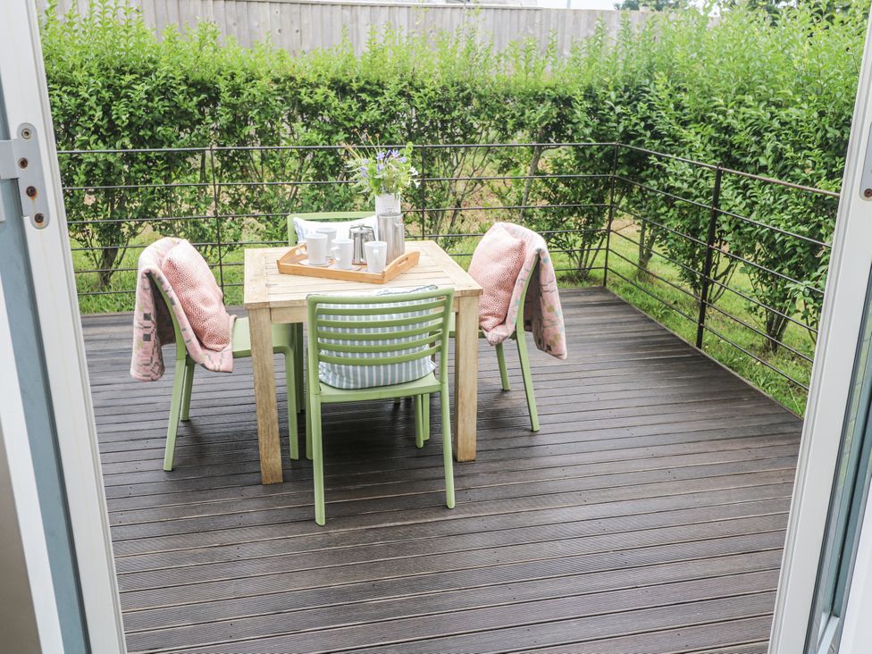 A table and chairs on a patio at Una, Lodge 70, Carbis Bay