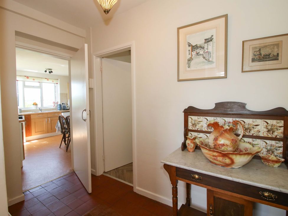A hallway with a vase on a table at Shepherd's Cottage Eudon Burnell near Bridgnorth