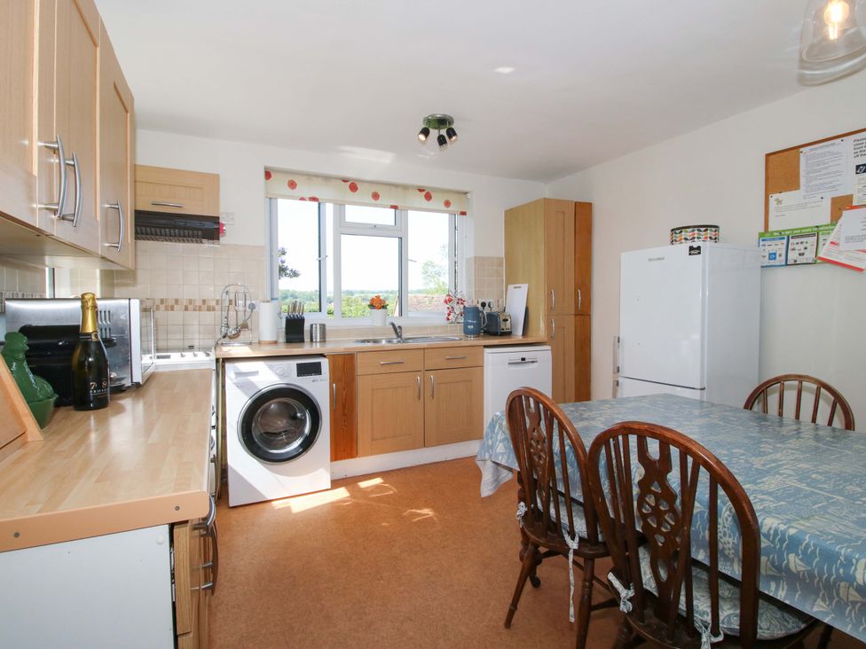 A kitchen with a table and chairs at Shepherd's Cottage in Eudon Burnell near Bridgnorth