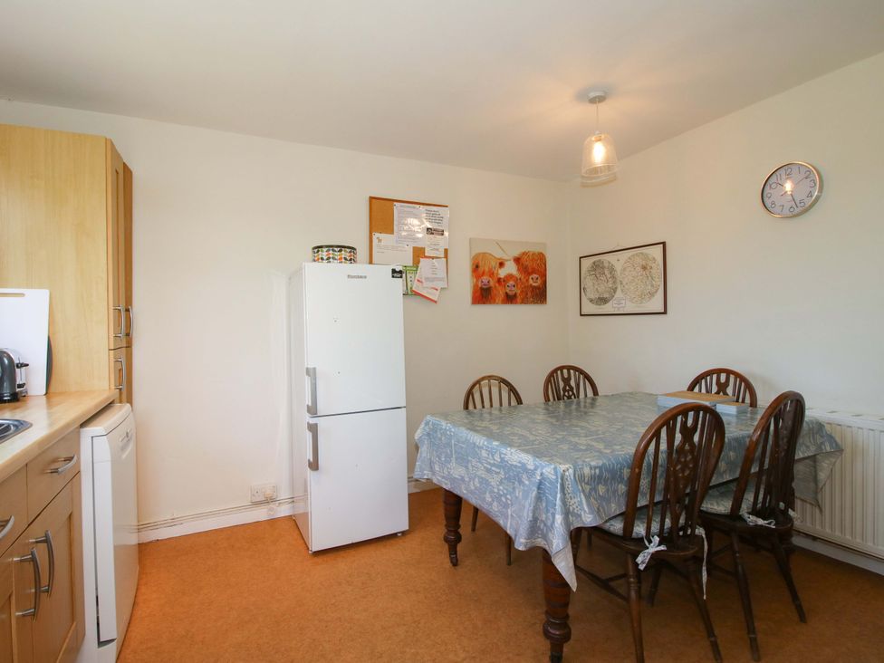 A kitchen with a dining table and chairs at Shepherd's Cottage Eudon Burnell near Bridgnorth