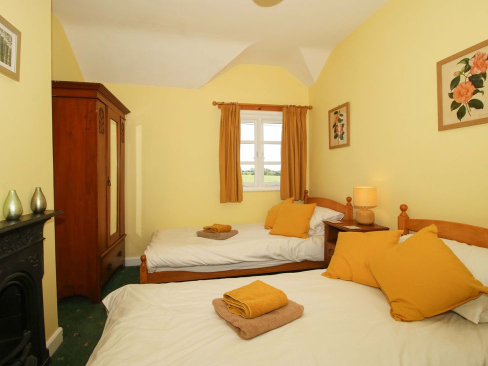 A bedroom with two single beds and a wardrobe at Shepherd's Cottage Eudon Burnell near Bridgnorth