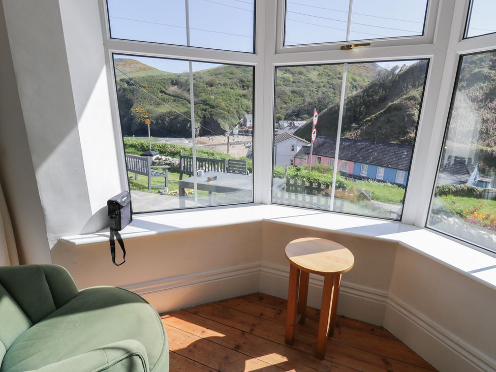 A living room with a window seating and a table at Brynmorfa in Llandysul