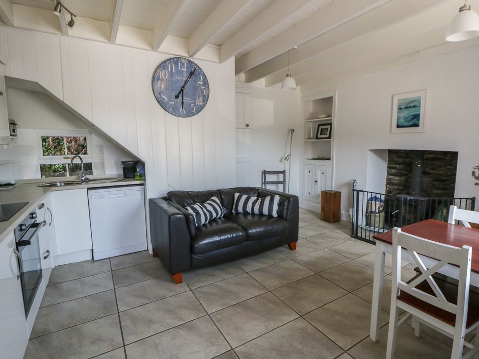 A living room with a couch and dining table at Brynmorfa in Llandysul