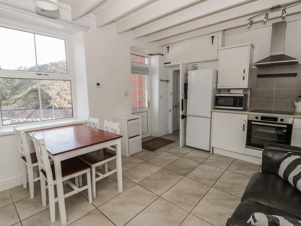 A kitchen with a table and chairs at Brynmorfa in Llandysul