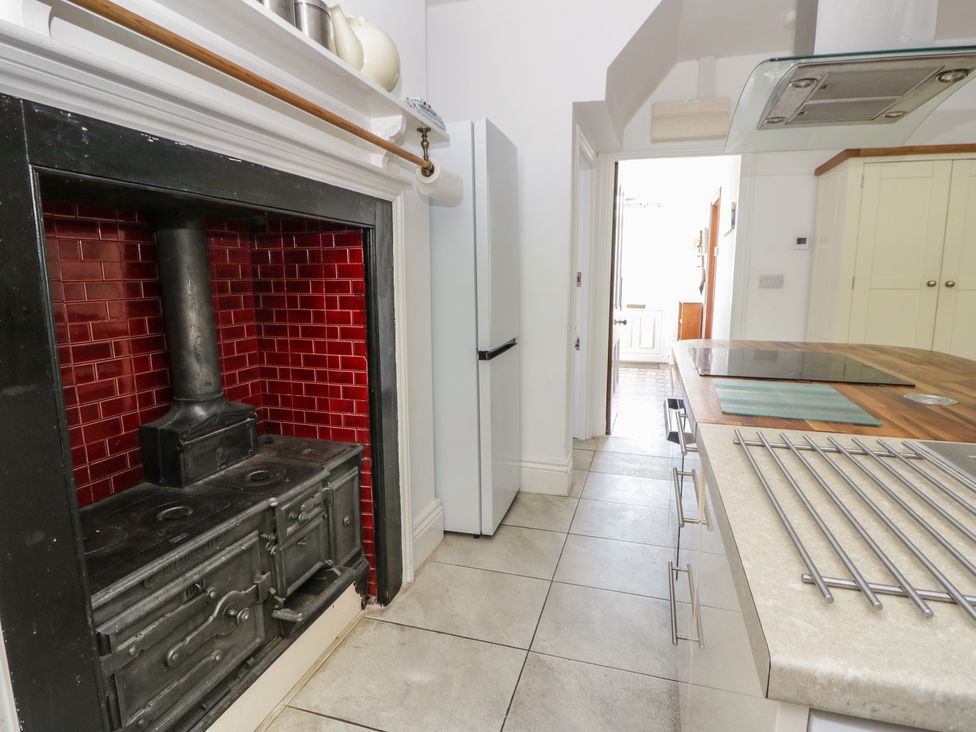 A kitchen with a stove and refrigerator at Brynmorfa in Llandysul