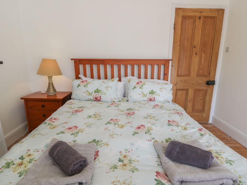A bedroom with a bed and bedside table at Brynmorfa in Llandysul