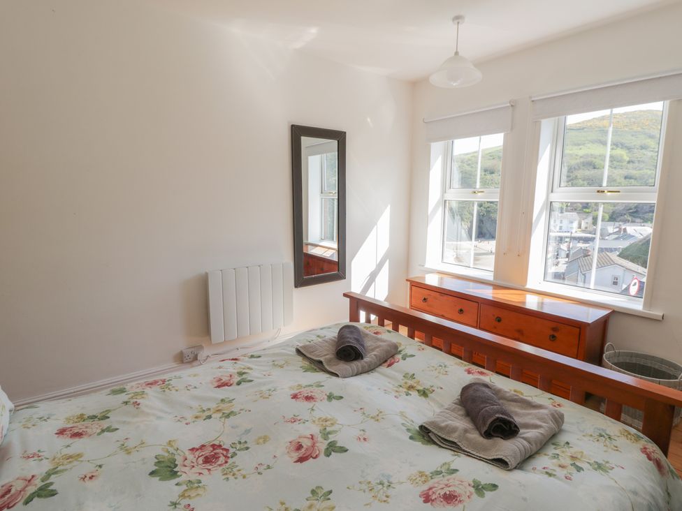 A bedroom with a bed and dresser at Brynmorfa in Llandysul