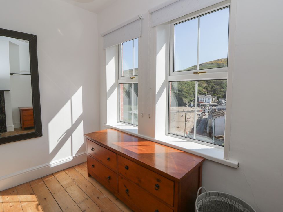 A bedroom with a dresser and windows at Brynmorfa in Llandysul