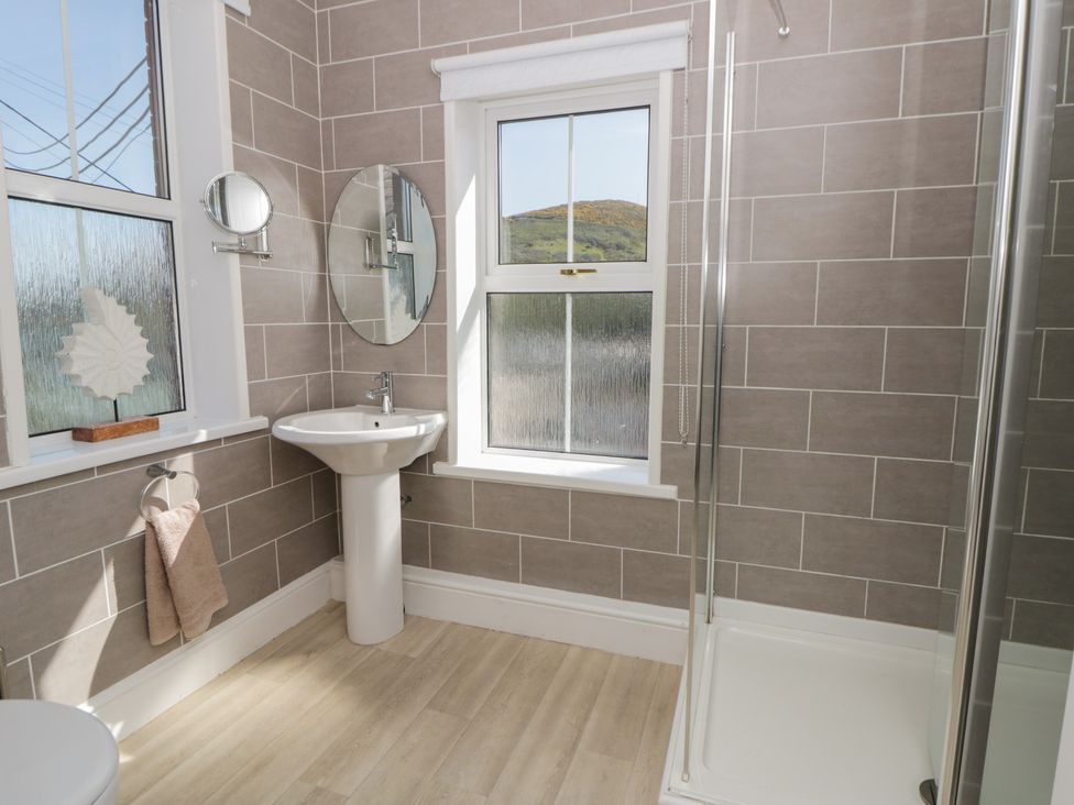 A bathroom with a sink and shower at Brynmorfa in Llandysul