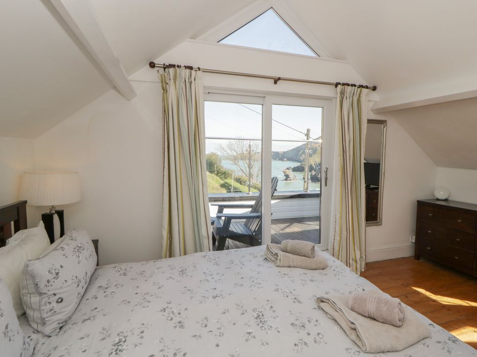 A bedroom with a bed and curtains at Brynmorfa Llandysul