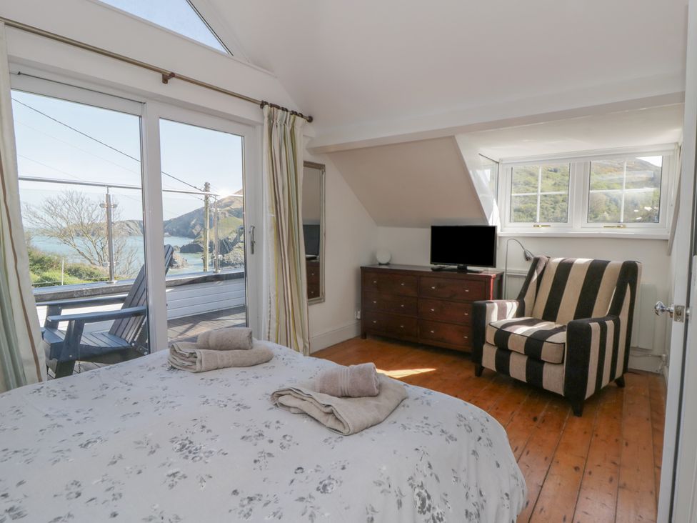 A bedroom with a bed and television at Brynmorfa in Llandysul