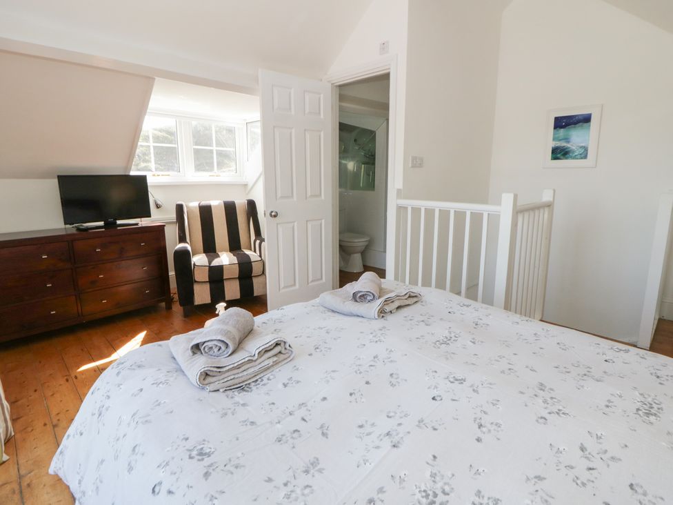 A bedroom with a bed and television at Brynmorfa in Llandysul
