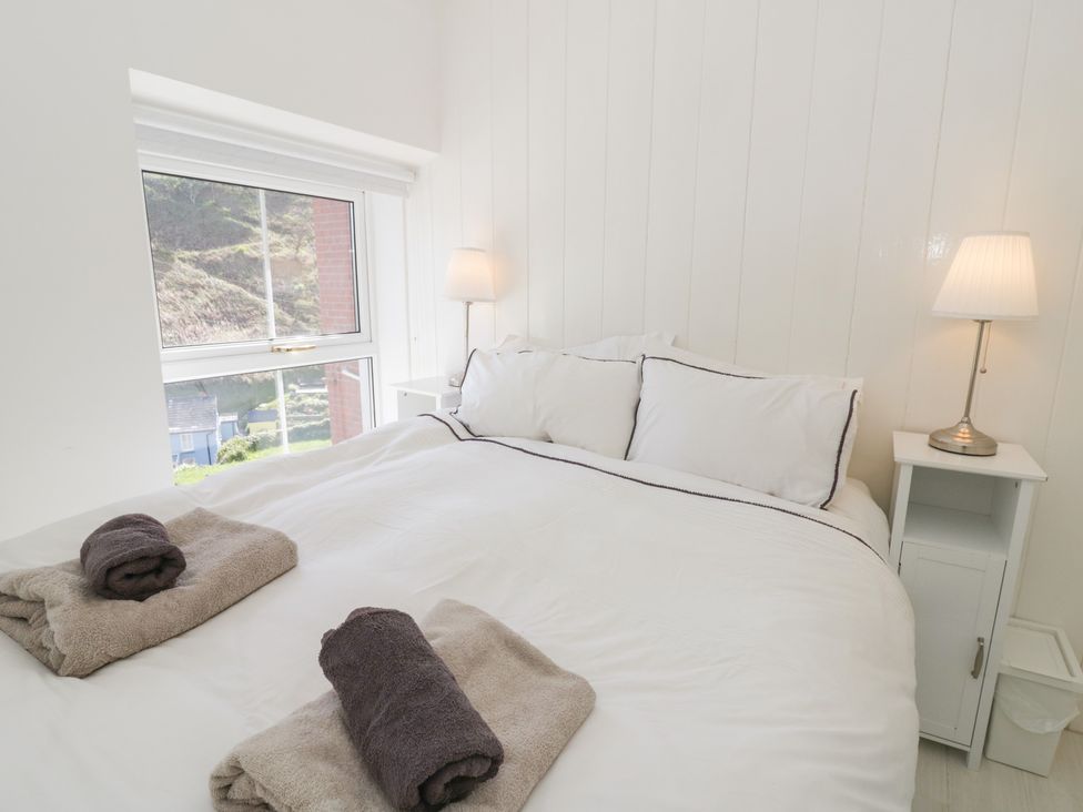 A bedroom with a bed and nightstand at Brynmorfa in Llandysul