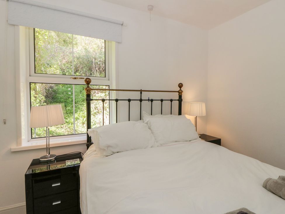 A bedroom with a bed and nightstand at Brynmorfa Llandysul