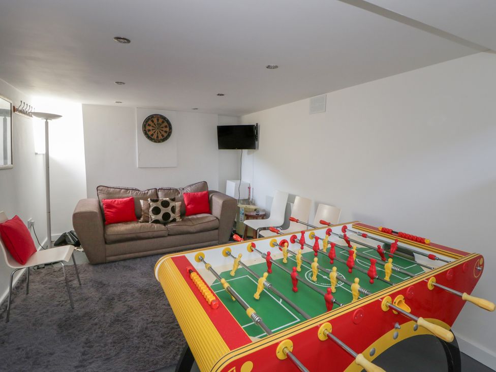 A snug with a foosball table and seating area at Brynmorfa in Llandysul