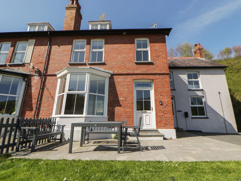 A house with a patio and furniture at Brynmorfa in Llandysul