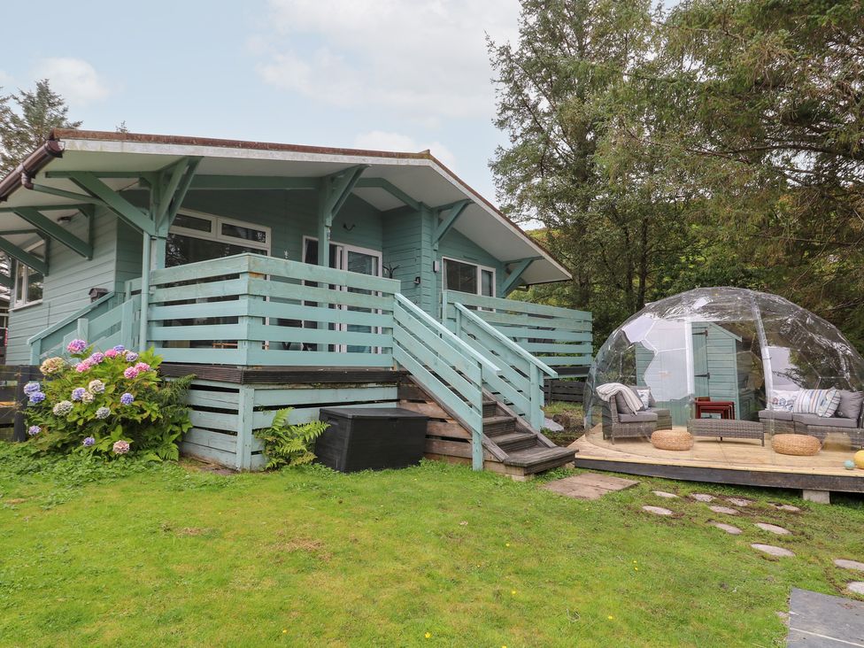 A house with a deck and outdoor seating at Scarba in Oban