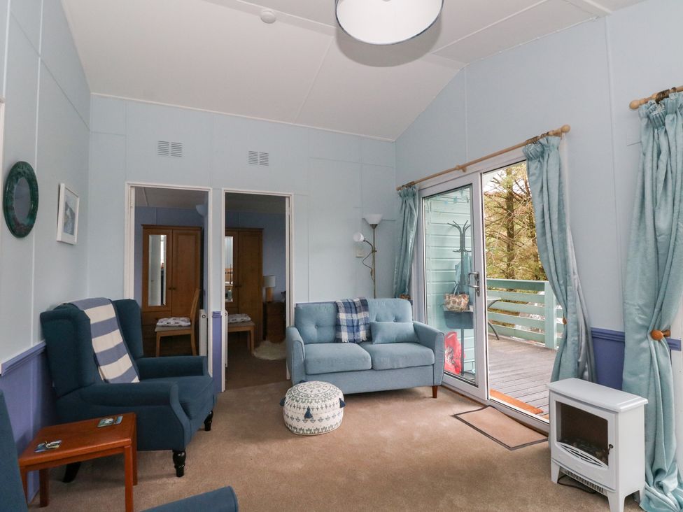 A living room featuring a sofa and armchair at Scarba in Oban