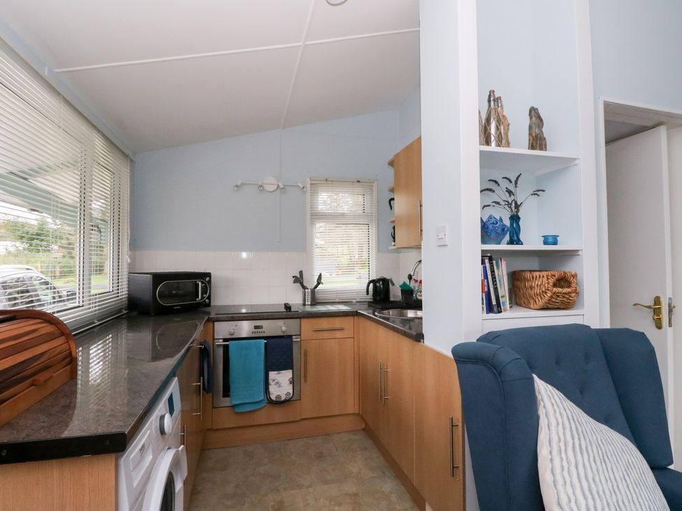 A kitchen with appliances and furniture at Scarba in Oban