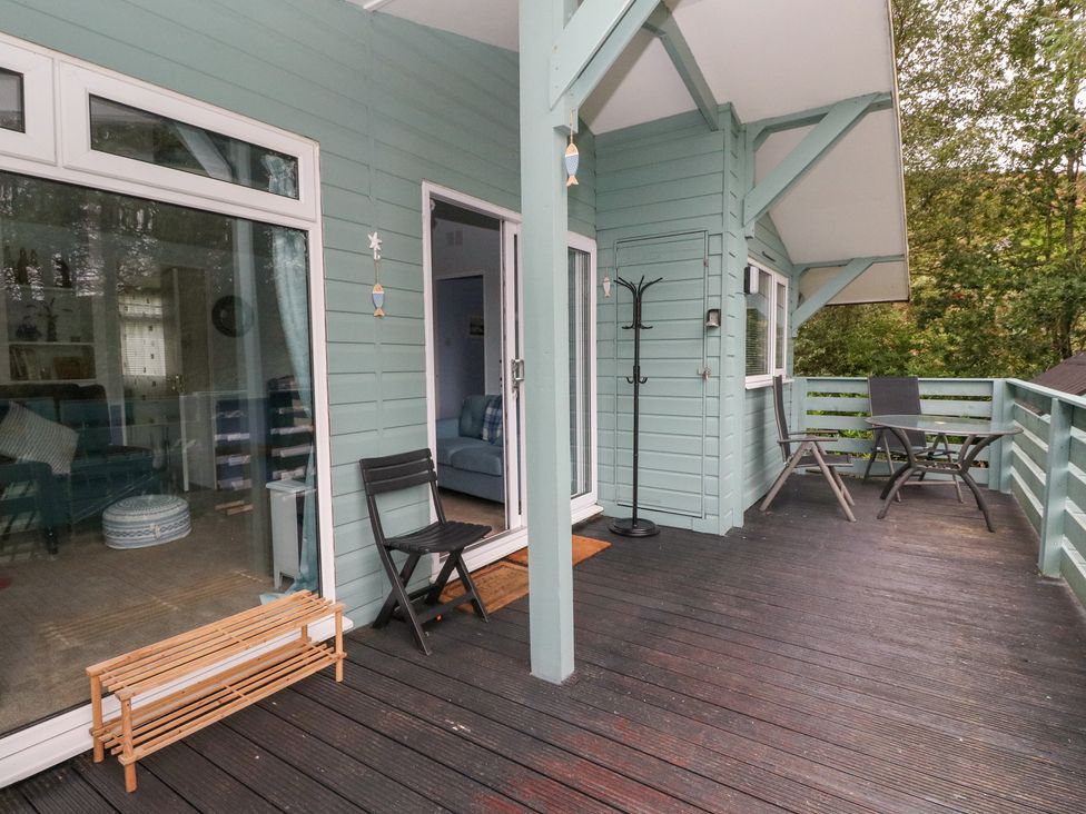 An outdoor area with a deck, chairs and table at Scarba in Oban