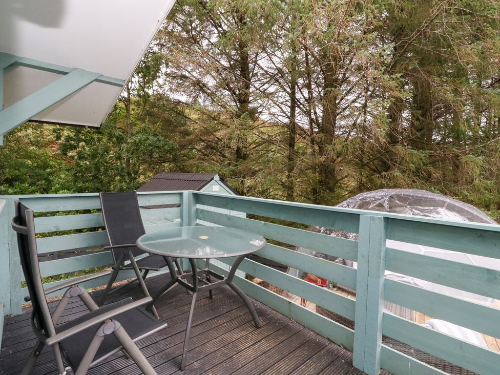 A deck with a table and chairs at Scarba in Oban