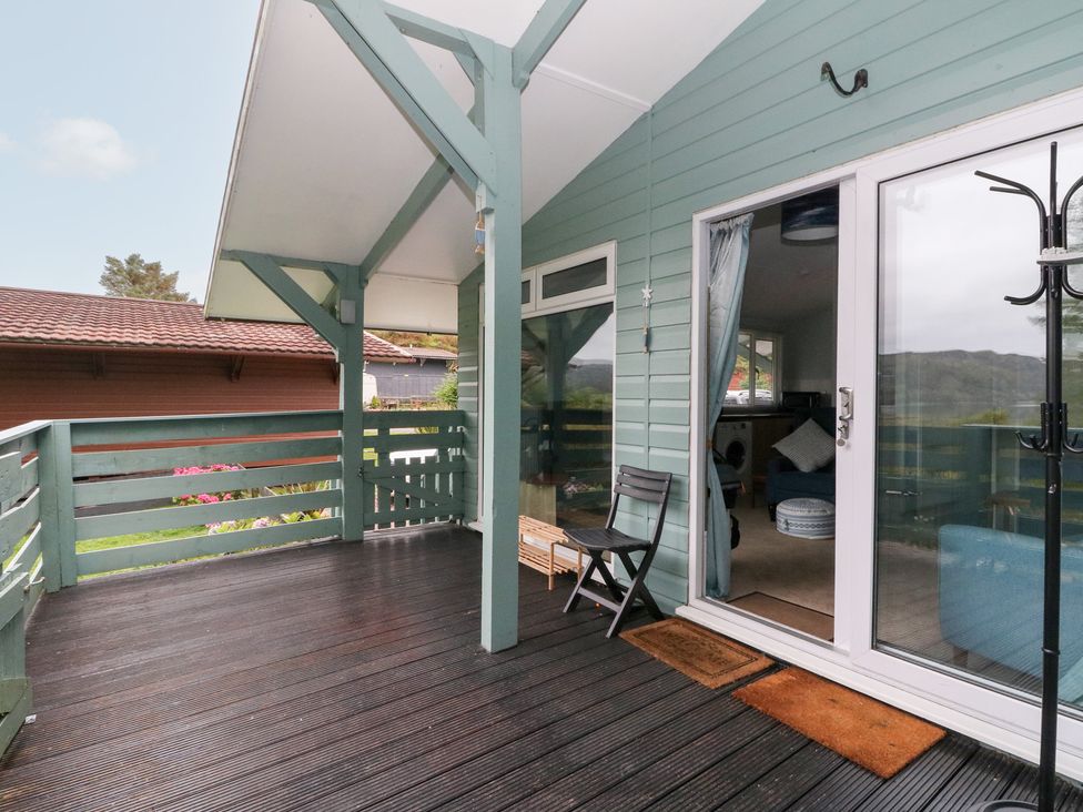 An outdoor area with a deck and chair at Scarba in Oban