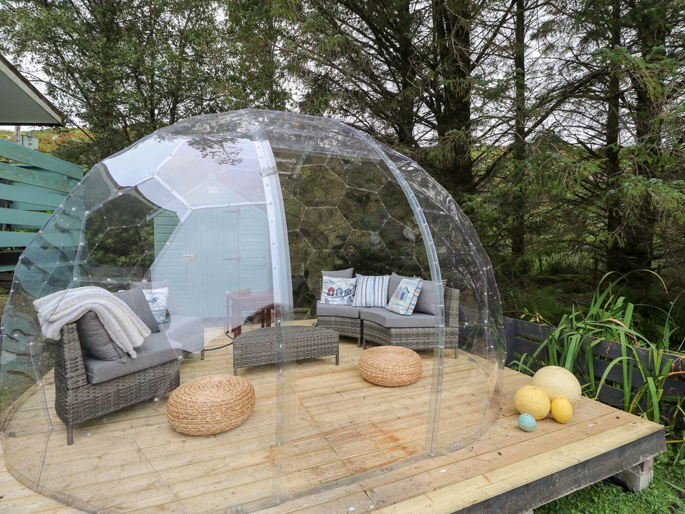 An outdoor seating area with a transparent dome and seating at Scarba in Oban