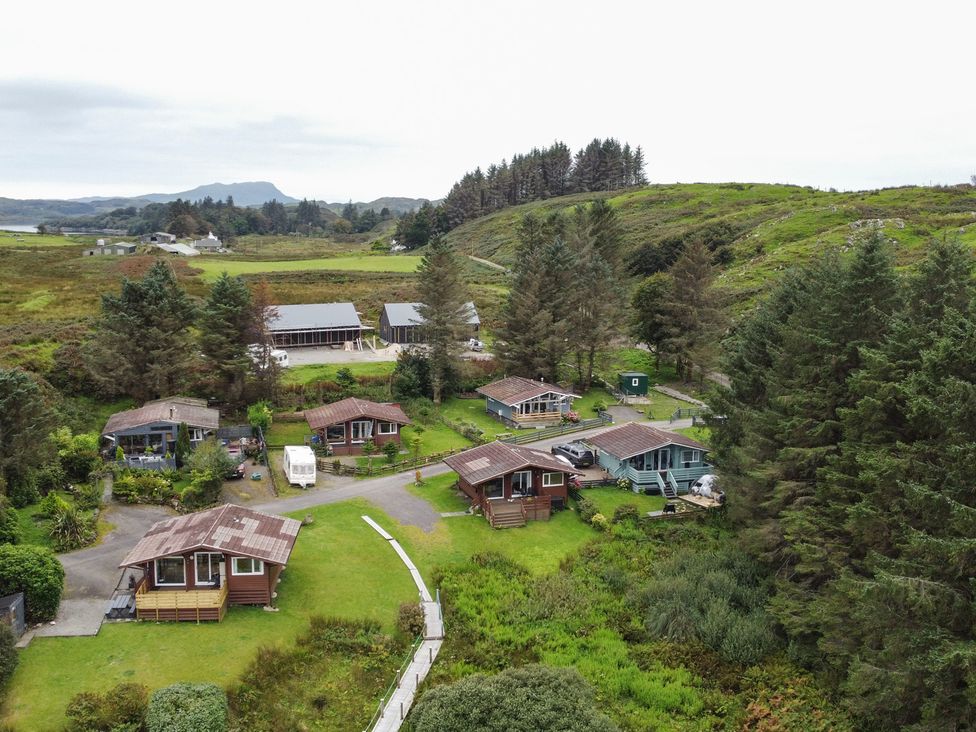 An outdoor area with cabins and trees at Scarba, Balvicar, Isle Of Seil