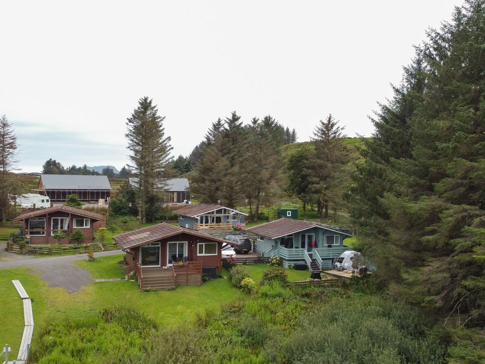 An outdoor area with cabins and trees at Scarba in Balvicar, Isle Of Seil