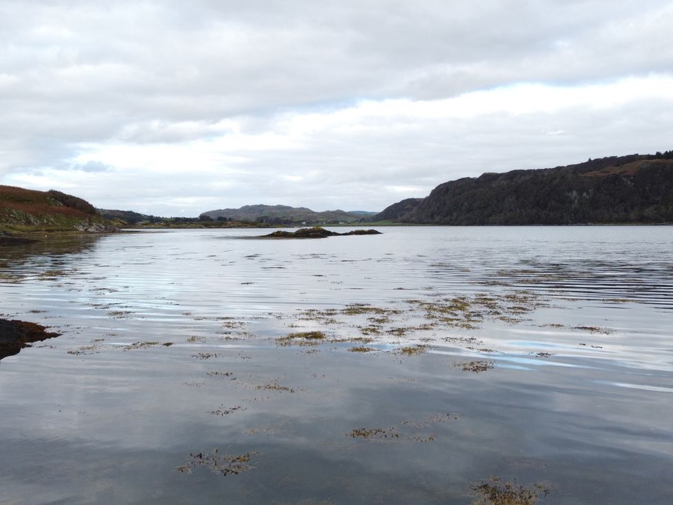 A body of water with hills in the background at Scarba, Balvicar, Isle Of Seil