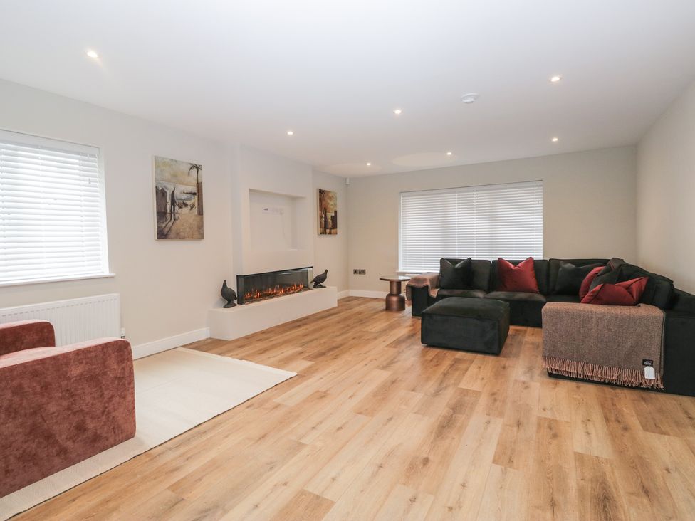 A living room with a sofa and fireplace at Cross Winds in Clapham