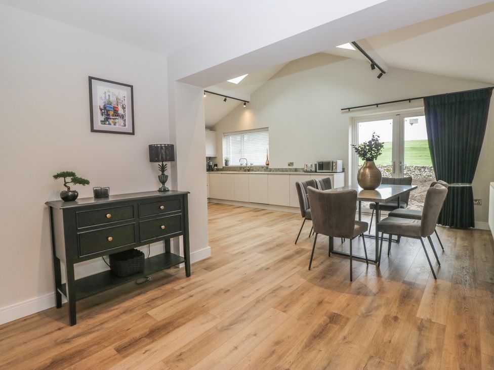 A dining room featuring a table and chairs at Cross Winds in Clapham