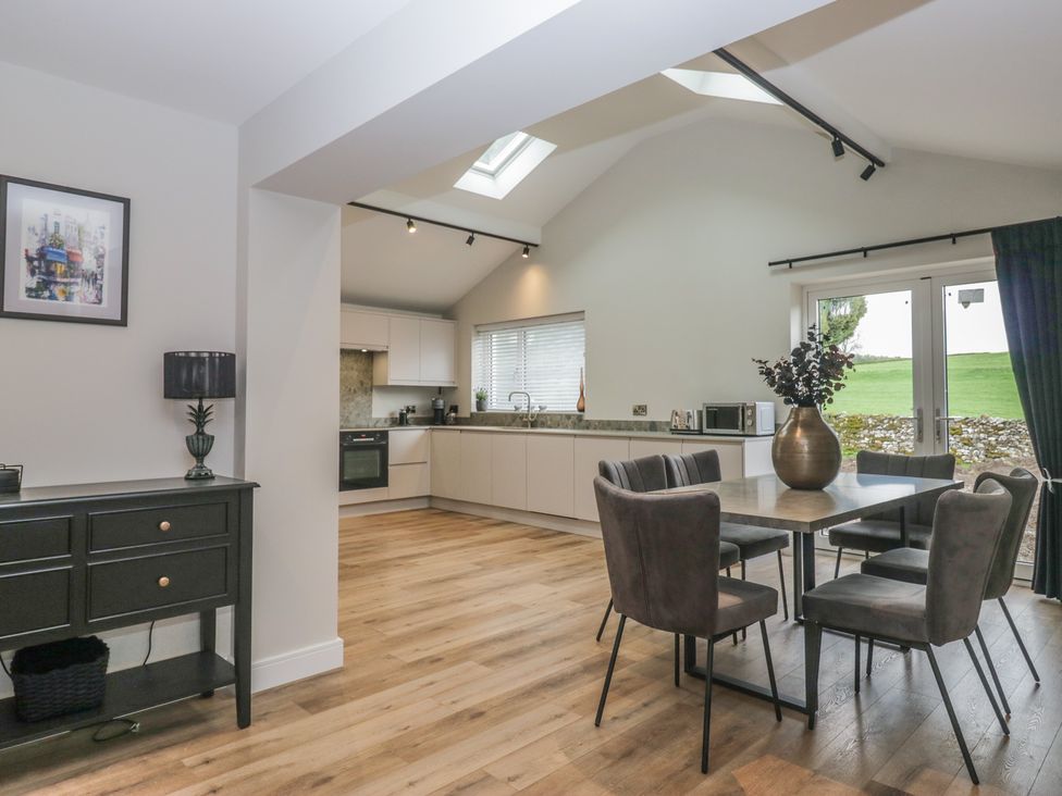 A kitchen with a table and chairs at Cross Winds in Clapham