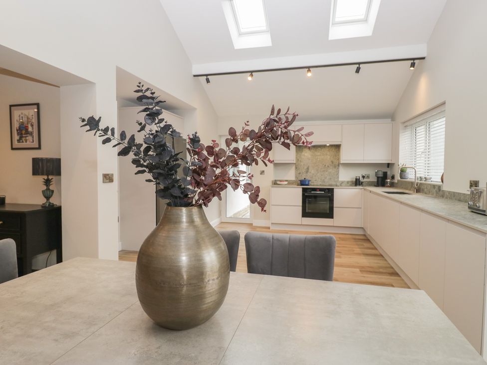 A kitchen with a table and a vase at Cross Winds in Clapham