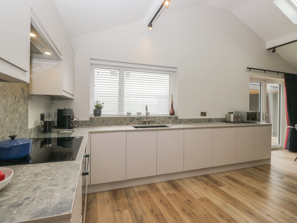 A kitchen with cabinets and appliances at Cross Winds Clapham