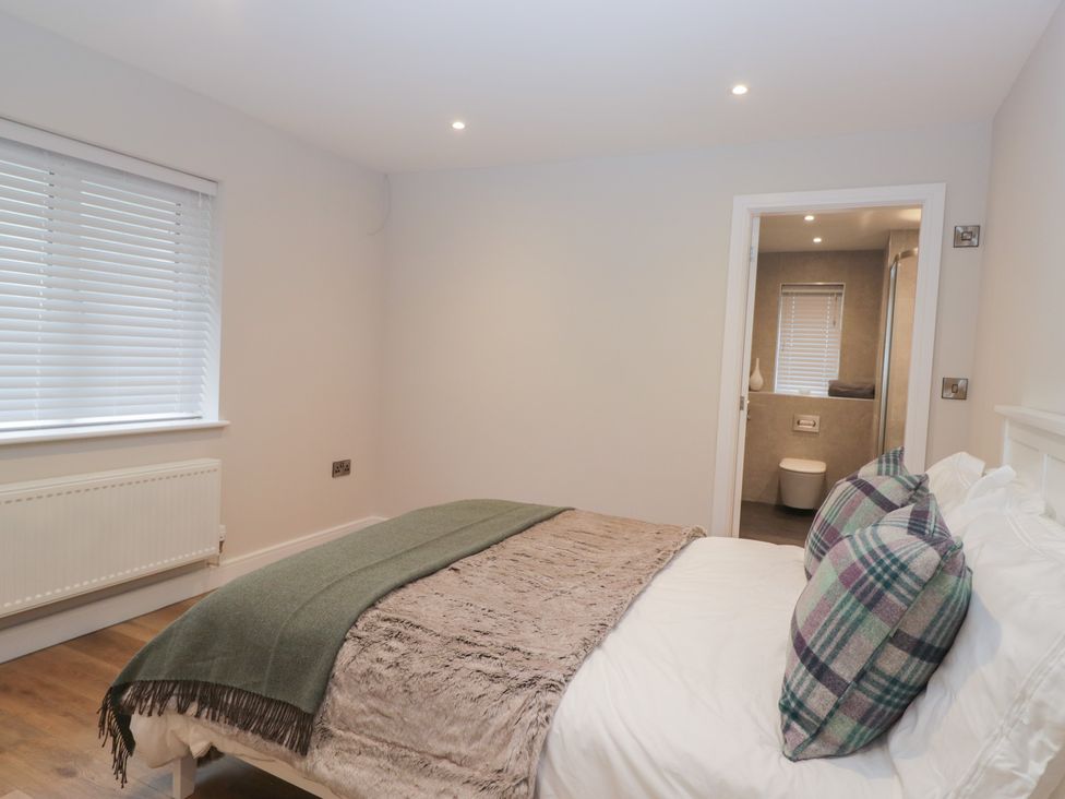 A bedroom with a bed and adjoining bathroom at Cross Winds in Clapham