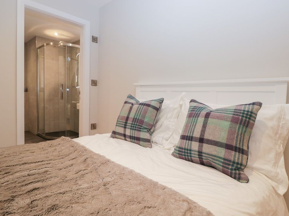A bedroom with a bed and an adjoining bathroom at Cross Winds in Clapham