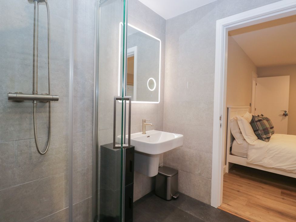 A bathroom with a shower and sink at Cross Winds in Clapham