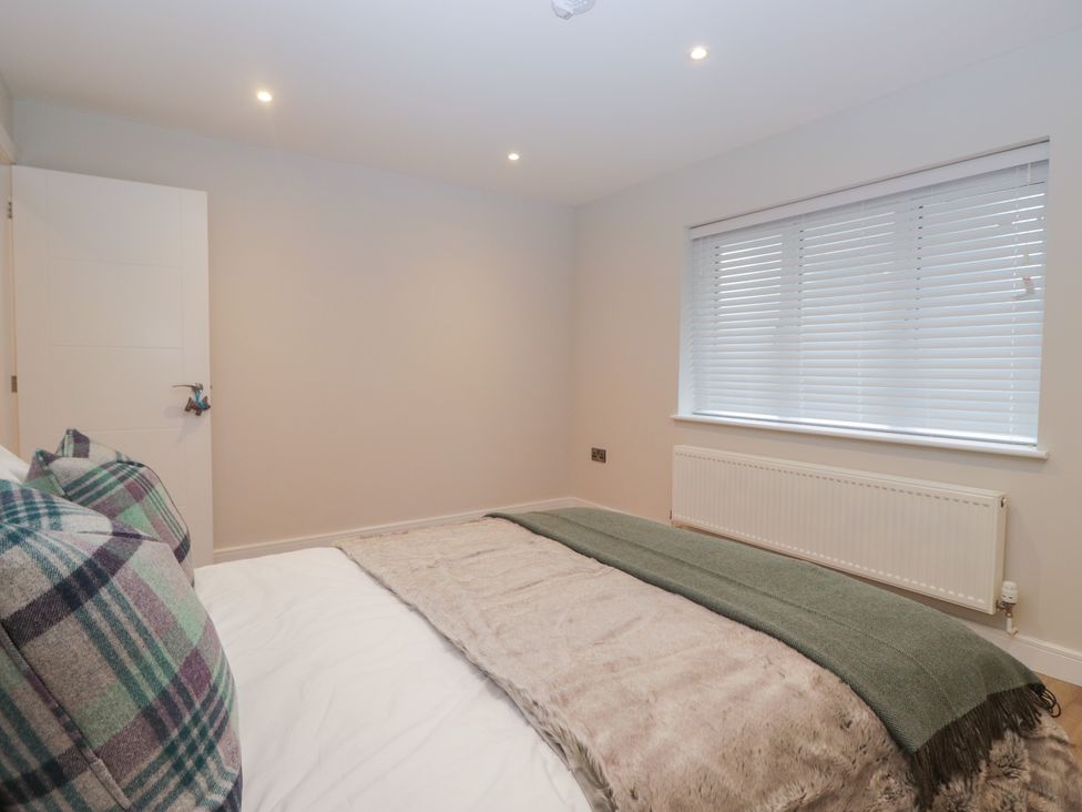 A bedroom with a bed and a window at Cross Winds in Clapham