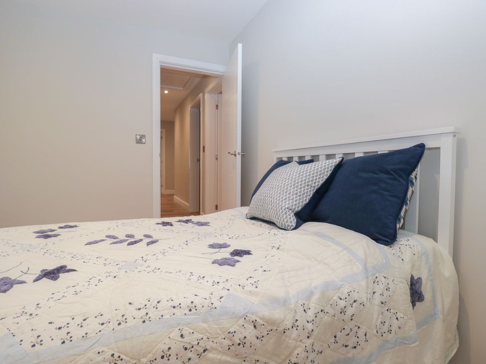 A bedroom with a bed and a door at Cross Winds in Clapham