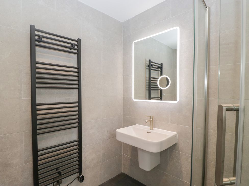 A bathroom with a wash basin and towel radiator at Cross Winds in Clapham