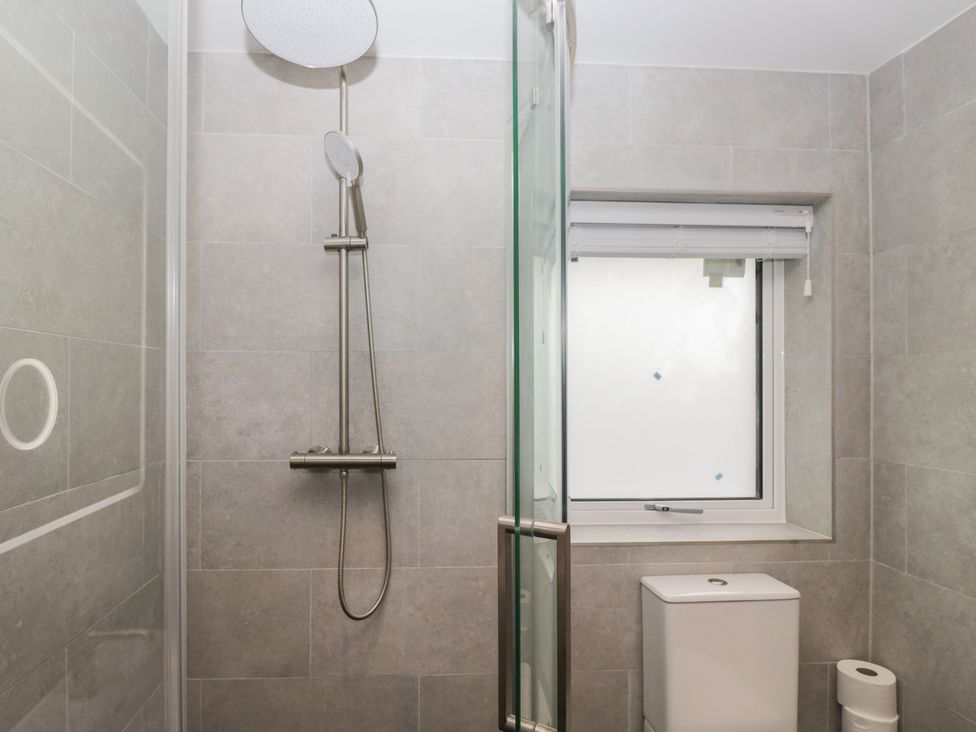 A bathroom with a shower and toilet at Cross Winds in Clapham