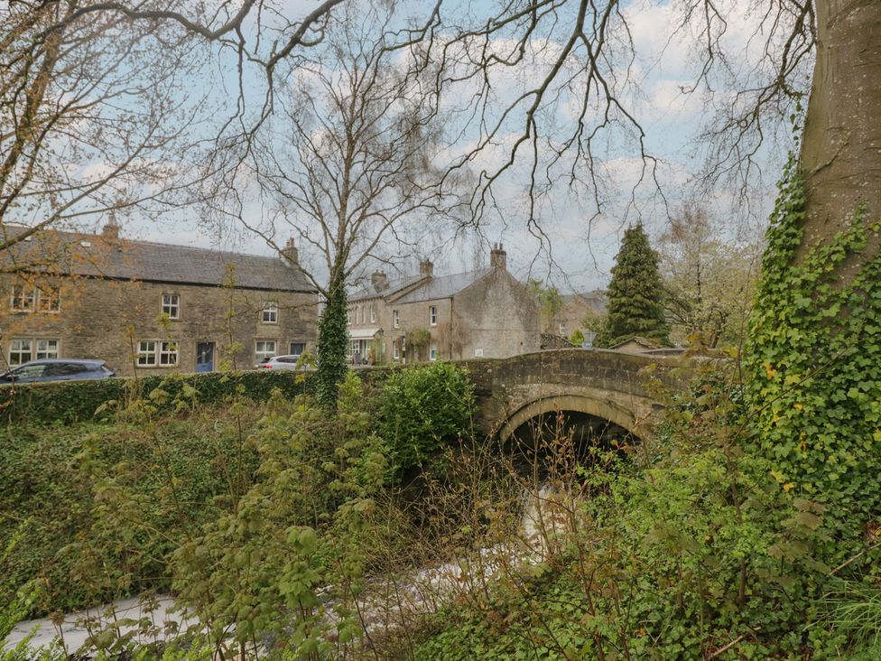 A view of a bridge and houses with trees at Cross Winds in Clapham